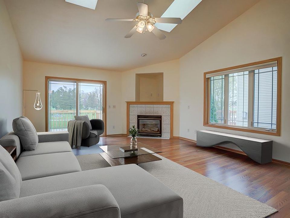Main living room with walk-out to private 12x14 deck, gas fireplace, 2 skylights, LVP flooring. Virtually staged