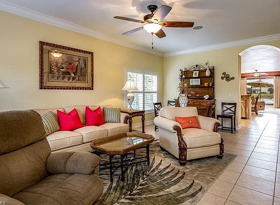 Enter a Living Room/Dining Area with Crown Molding