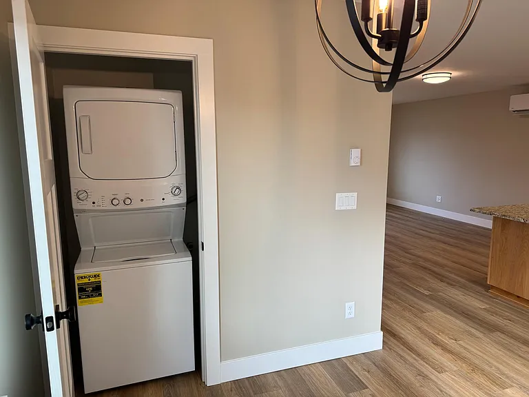 Stacked washer and dryer off of the dining room.