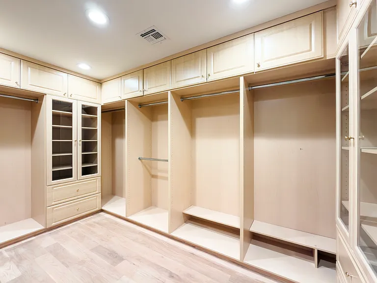 Dual-sided walk-in closet with custom cabinetry provides abundant storage in this Beverly Hills luxury rental at 1094 Garden Lane, 90210.
