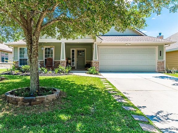The inviting front porch and lush greenery are part of the great ambiance of this home before even stepping inside