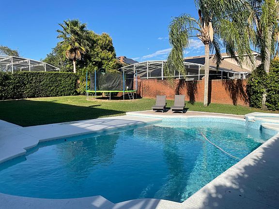 large fenced yard with newly refinished pool