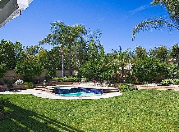 Enormous yard is secluded and serene with sparkling pool
