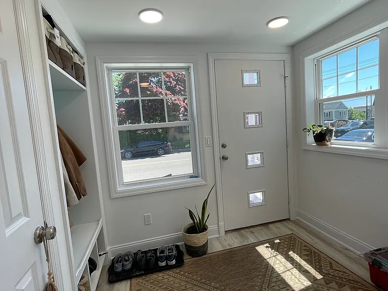 Front mudroom with closet and built in coat rack