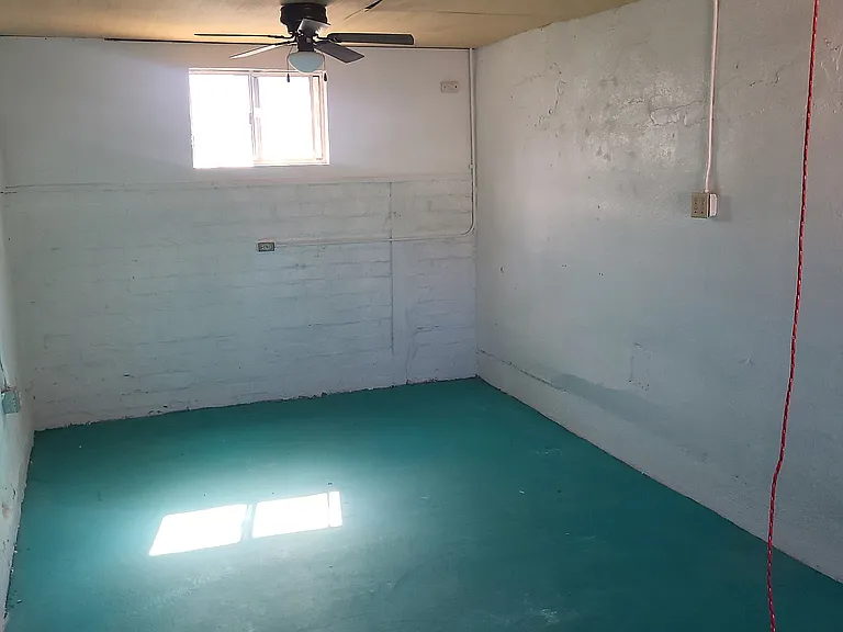 Great room has lots of natural light and ceiling fans