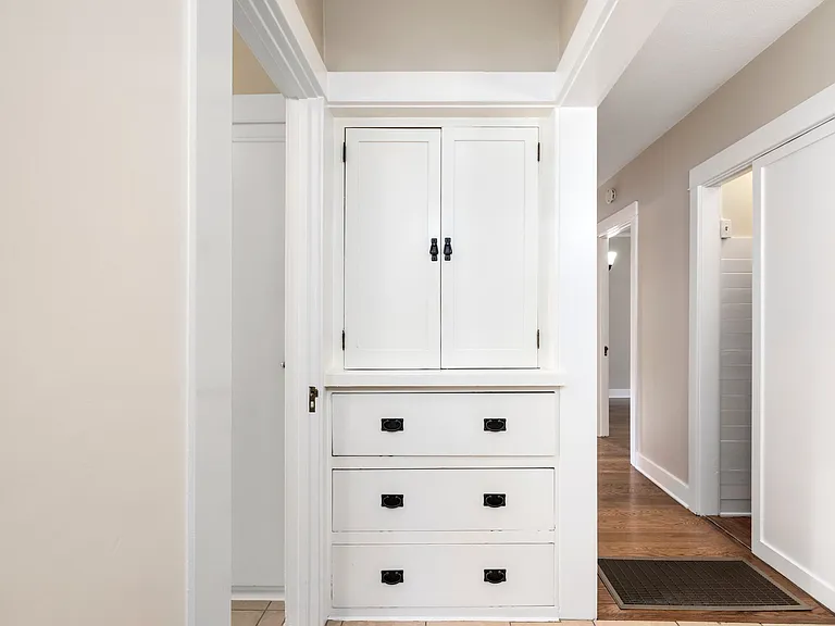 Hallway with additional storage - linen closet and adjacent full height closet