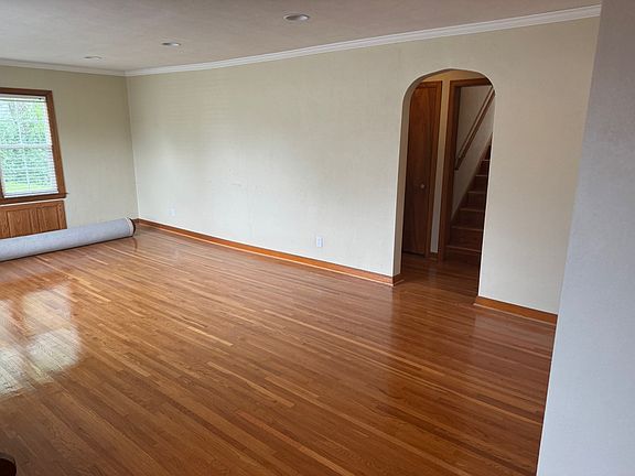 Living room, looking into hallway that goes upstairs.