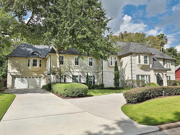 FOUR CAR GARAGE WITH ADDED AIR CONDITIONED STORAGE UNIT (11X18) - A stunning photo of the East side of the home with additional driveway space. Straight ahead is the 4 car oversized tandem garage with additional air conditioned storage space. New Ene