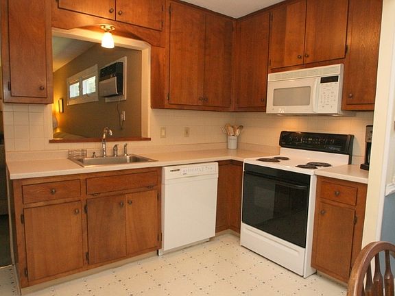 Opening above sink looks into family room
