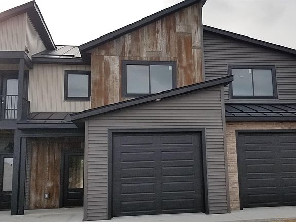 modern farmhouse rustic exterior of galvalume rustic siding, board and baton and traditional siding