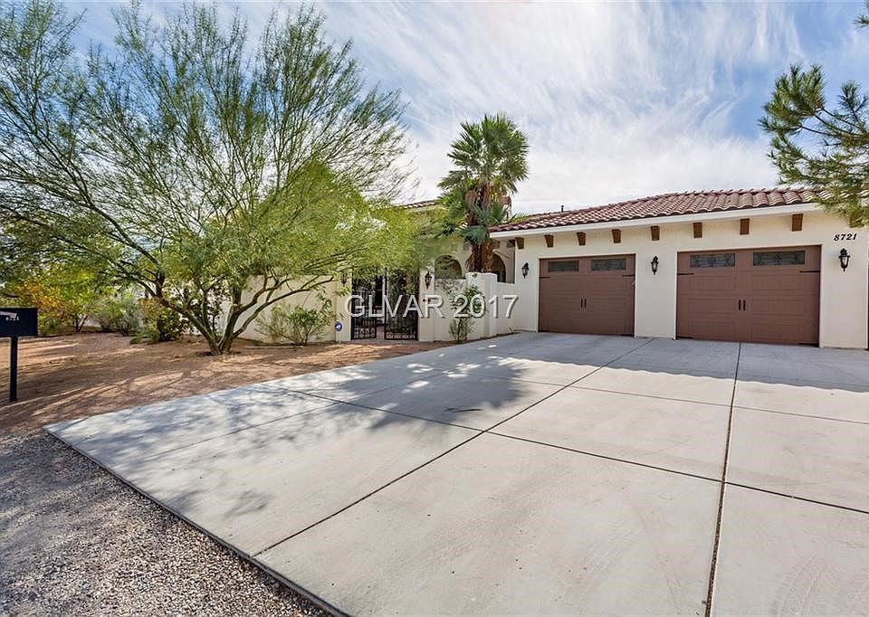 Front Exterior Showing Gate to Courtyard Entry and Two of the Four Garages