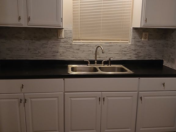 Newly remodelled kitchen with ceramic tile flooring