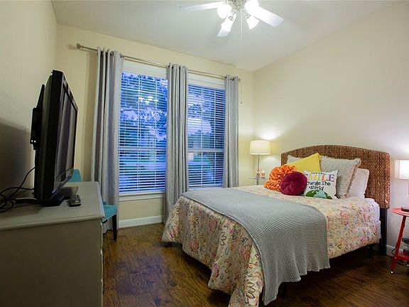 Guest bedroom or mother-in-law suite, on the first floor, with a view of the expansive front yard.