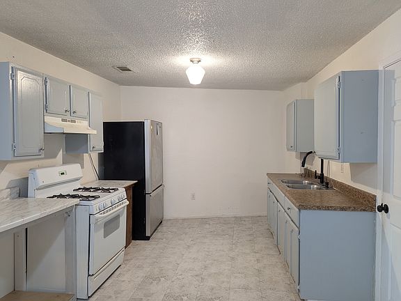 Kitchen with fridge and stove