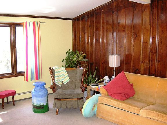 Living room with 2 knotty pine walls