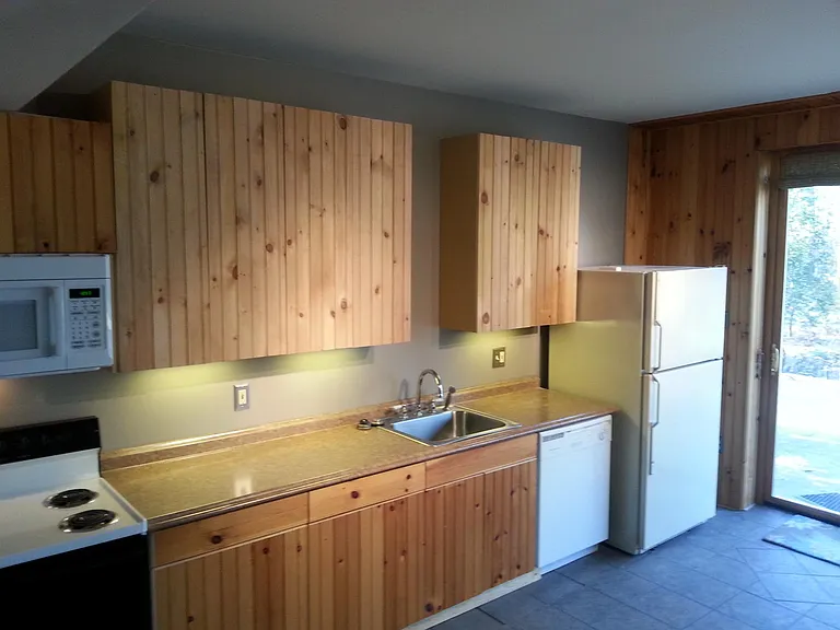 Kitchen includes Fridge, dishwasher, oven, stove, microwave, under cabinet lighting and lots of cabinets. Pantry to left of oven.