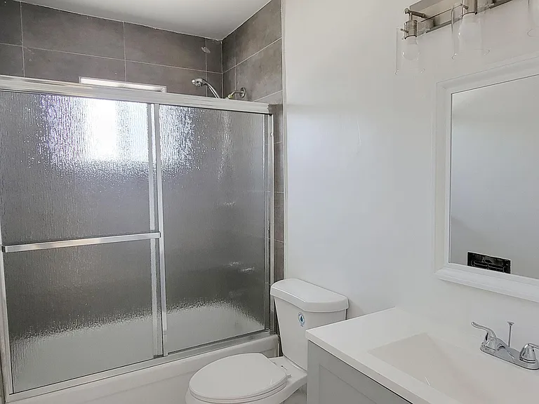 Bathroom with white fixtures and natural light in 2-bedroom apartment at the Hardison Apartments in Pasadena, California.