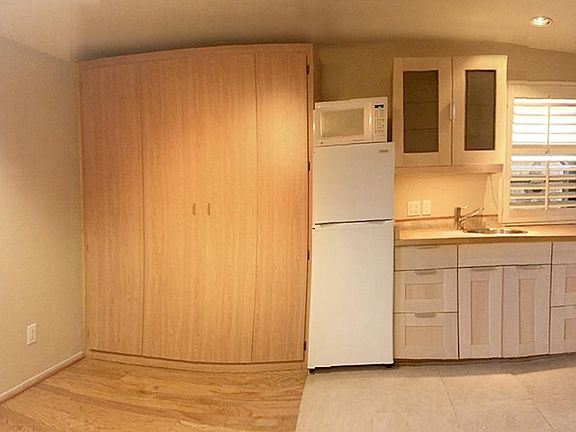 East view, queen wall bed, kitchenette and outdoor patio.