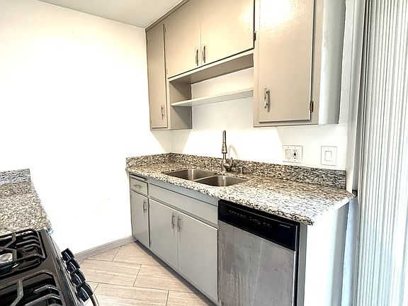 Full Remodeled Kitchen with Stone Countertops, Stainless Steel appliances: fridge, oven, microwave & dishwasher.