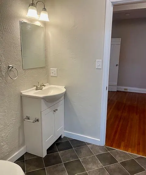 New LVP flooring being installed in the full bathroom