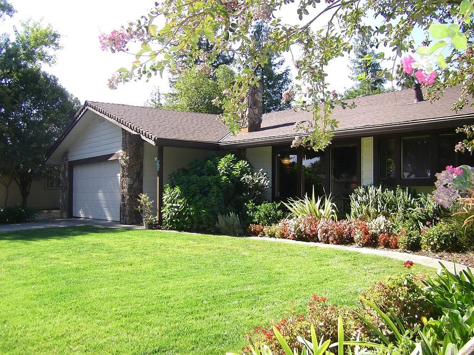 The nicest house on the block, filled with color and lovely yard! Easily maintained.