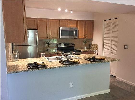 Kitchen with granite counters and stainless steel appliances.