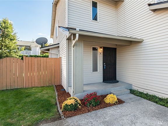 The entrance features a covered porch, and there's a gated entry to the fully fenced backyard.