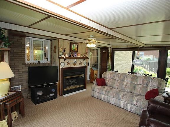 GORGEOUS 1st Floor 19x16 Family / Sun Room offering Newer Pella Windows including Hunter Douglas Custom Blinds and Sliding Doors