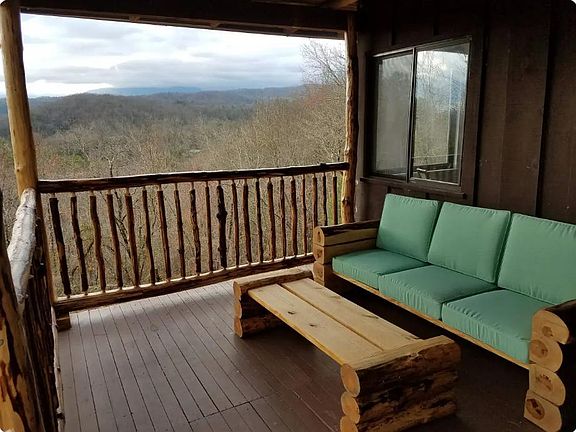 Perfect spot for morning coffee - handmade safety railings on porch and log couch and table made by host