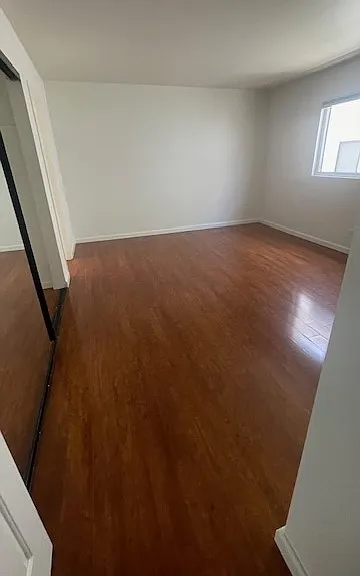 View from hallway into master bedroom. Large closet space and private bath to the back left.