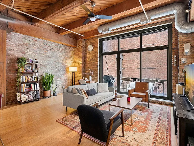 High ceilings with exposed brick make for a picturesque open living space