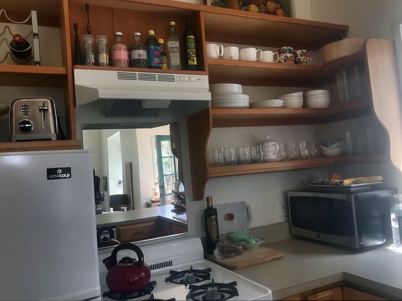 Kitchen, gas stove, refrigerator, open shelfs, dishwasher, window to garden
