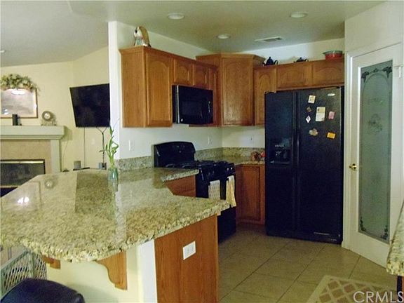 KITCHEN TILE FLOORS AND DROP IN STOVE MICRO WAVE AND DISHWASHER