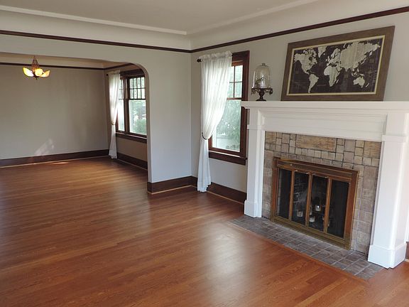 Spacious living room with fireplace and mantle.