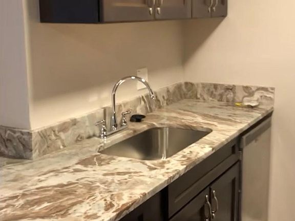 Beautiful new granite countertop, large single basin sink, and dishwasher