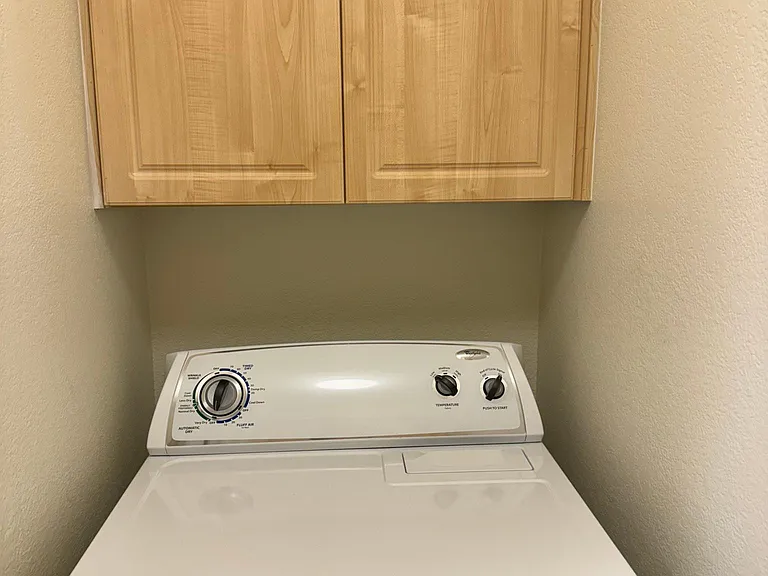 The washing machine a dryer in the laundry room off of the kitchen each have cabinets above for easy storage of paper goods, cleaning supplies, detergent, etc.