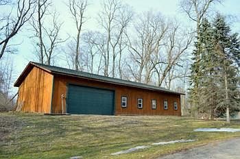30x60 horse barn adjacent to the home has a 2 car garage, 3 horse stalls, lots of lighting, and several exterior doors.  
