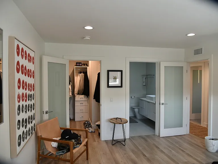 Primary bedroom looking at en suite bathroom and walk-in closet