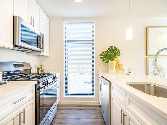 White Cabinets with brushed nickel pulls and Stainless Steel Appliance Package