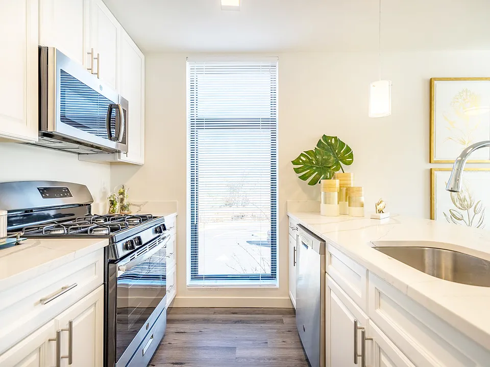 White Cabinets with brushed nickel pulls and Stainless Steel Appliance Package