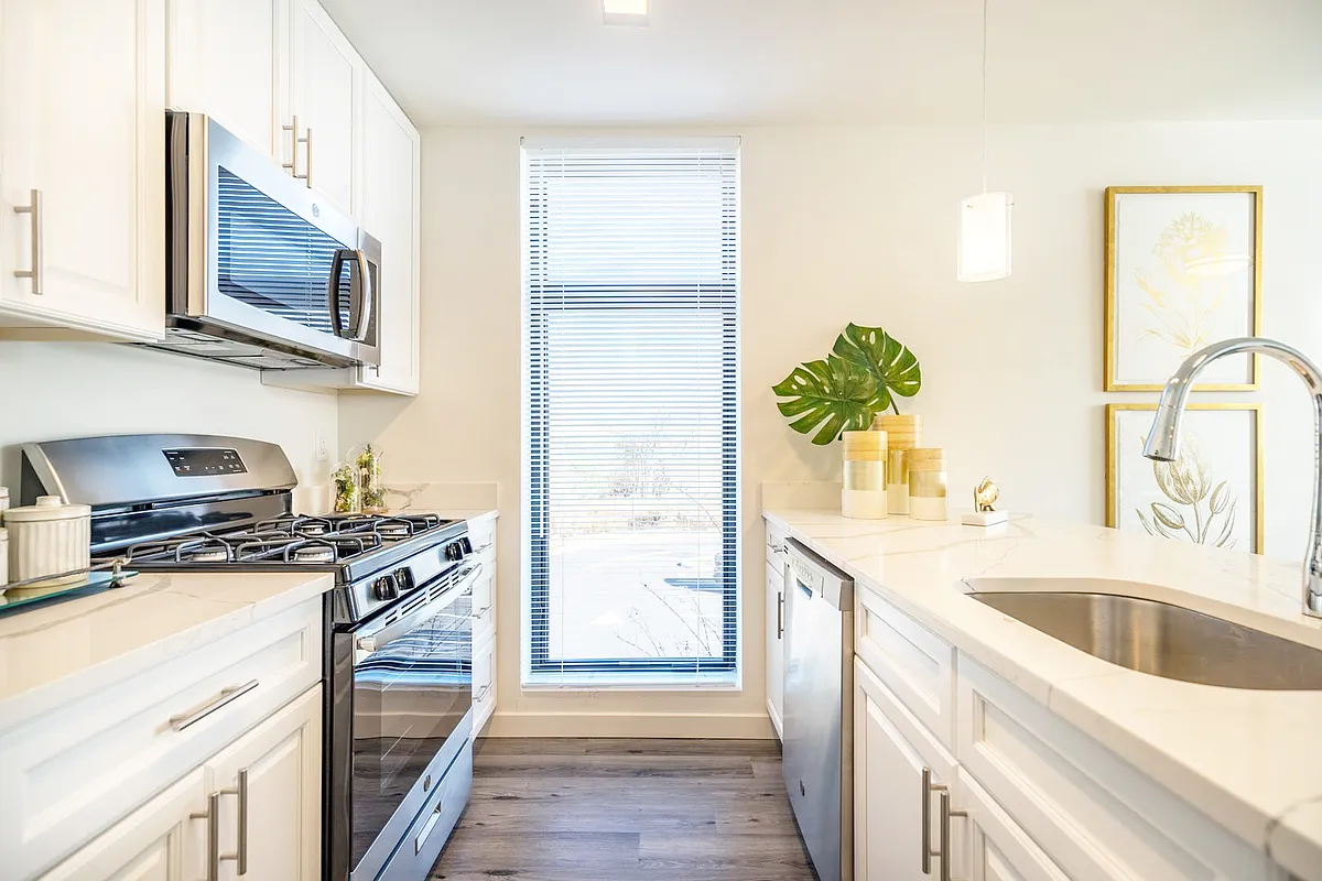 White Cabinets with brushed nickel pulls and Stainless Steel Appliance Package - The Ezra
