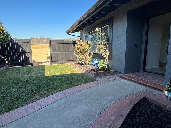 Beautiful Curb Appeal with Fresh Exterior Paint, Tropical Landscaping With Fruit Trees and courtyard