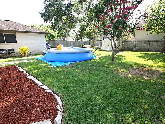 BEAUTIFUL BACKYARD WITH MATURE LANDSCAPING AND TREES