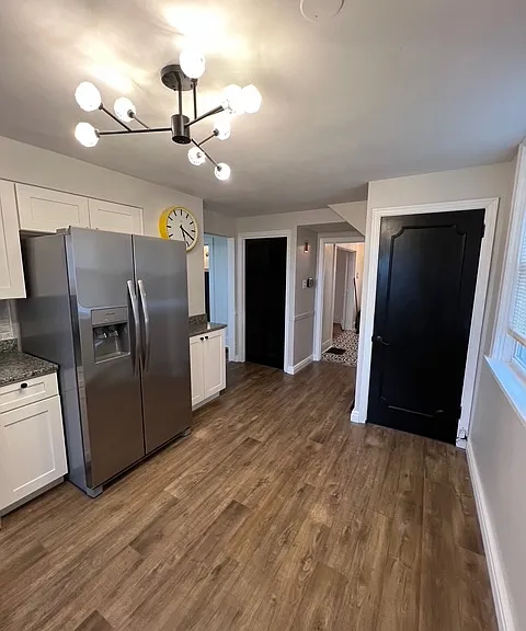 Basement door on right with a kitchen closet on the left.