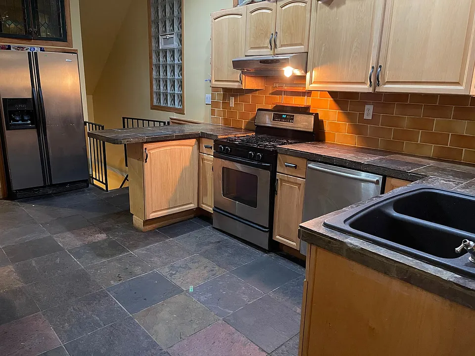 Large eat in kitchen with extra counter lots of cabinets and dishwasher