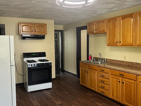 Spacious kitchen with new floors, plenty of cabinets, new ceiling and lighting with fan.