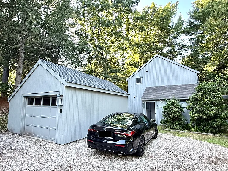 1 Car Garage, with door in rear. 3 spots additional on driveway.