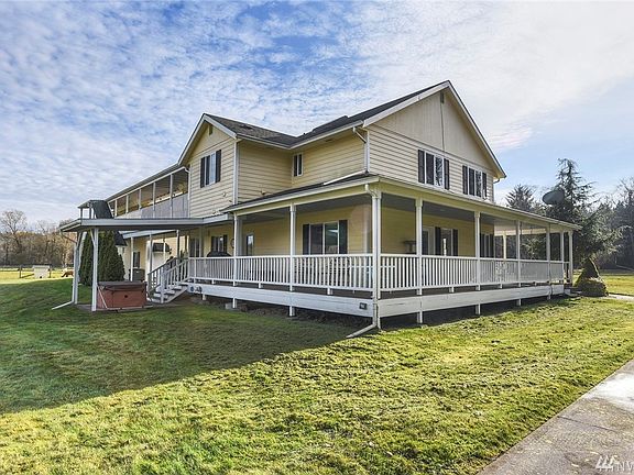 Large wrap around covered porch provides great views from every side. Covered hot tub and sports court.  