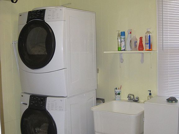 Oversized, remodeled laundry room with utility sink