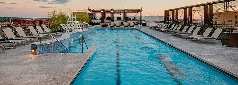 Rooftop swimming pool and sundeck with lounge seating